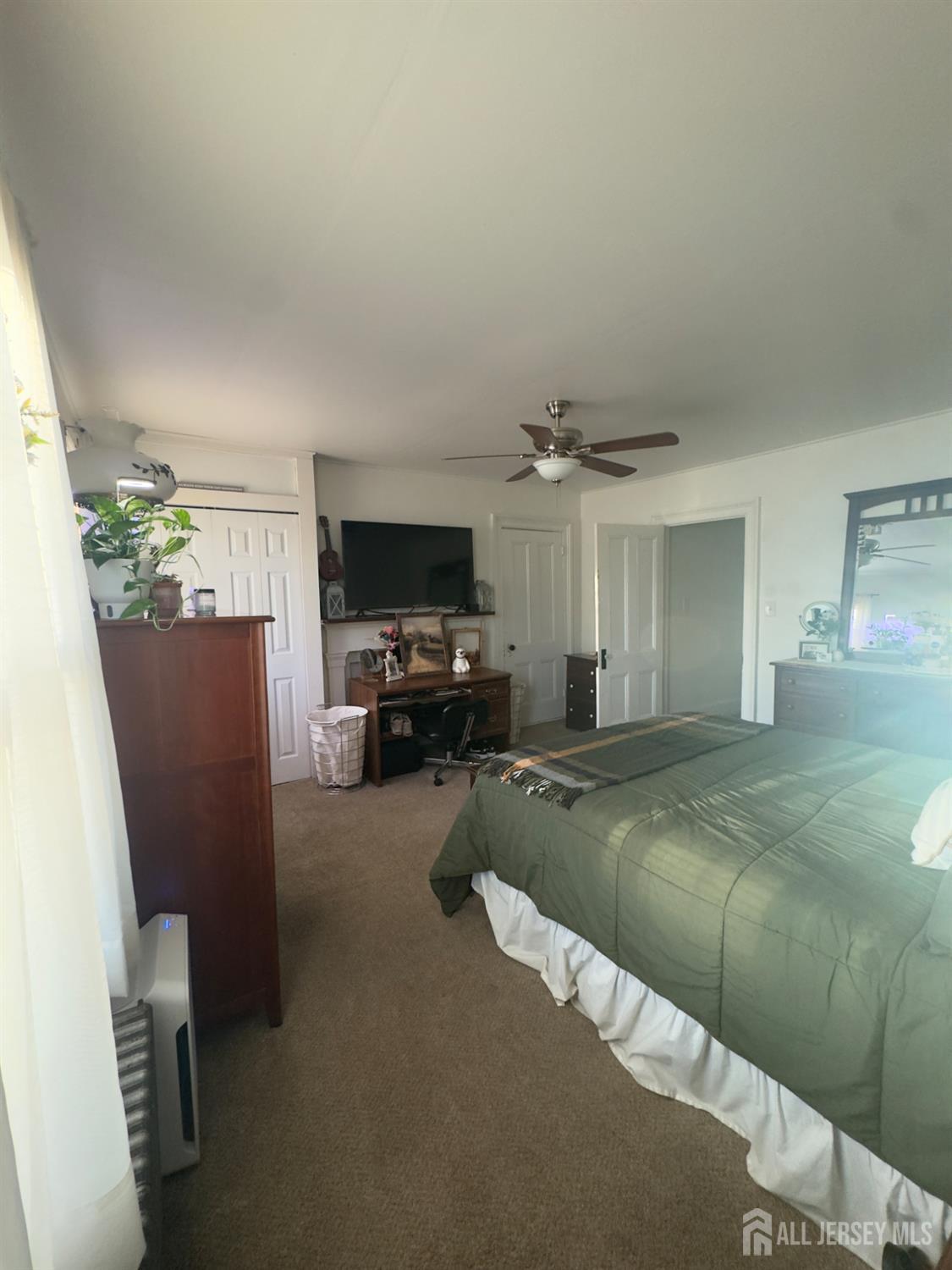 41 Atlantic Street Keyport, NJ 07735 - Photo 3 of 48 a bed room with a bed furniture and a flat screen tv