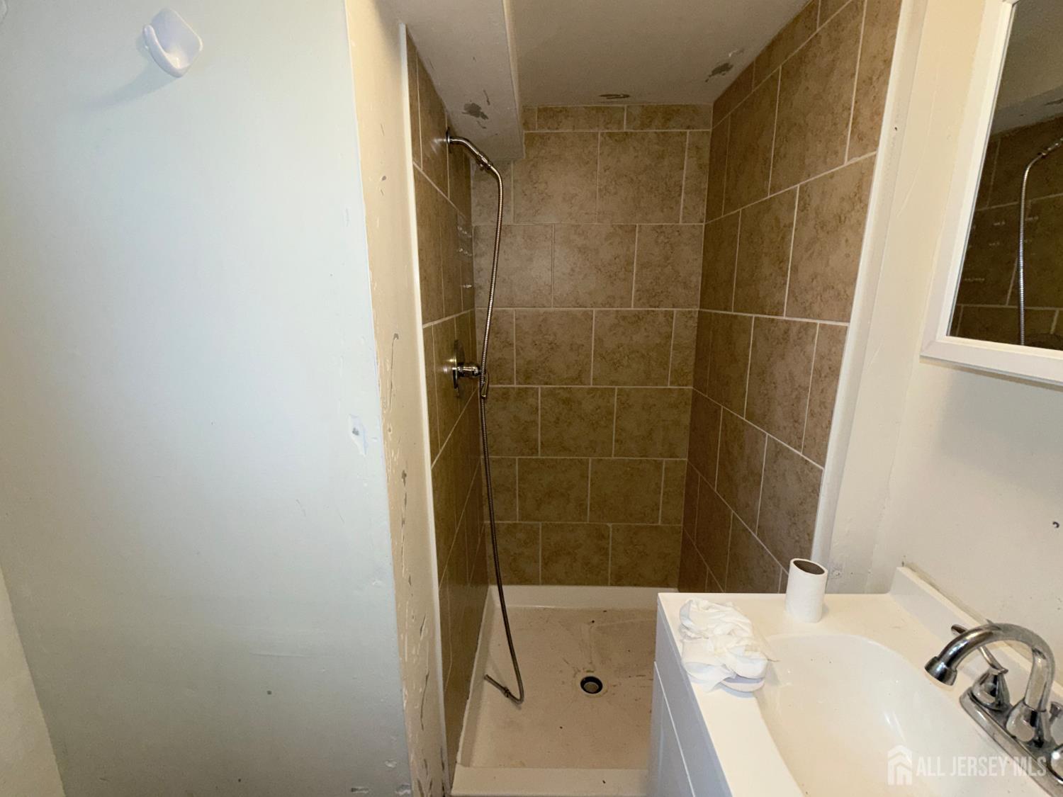41 Atlantic Street Keyport, NJ 07735 - Photo 31 of 48 a bathroom with a sink and shower