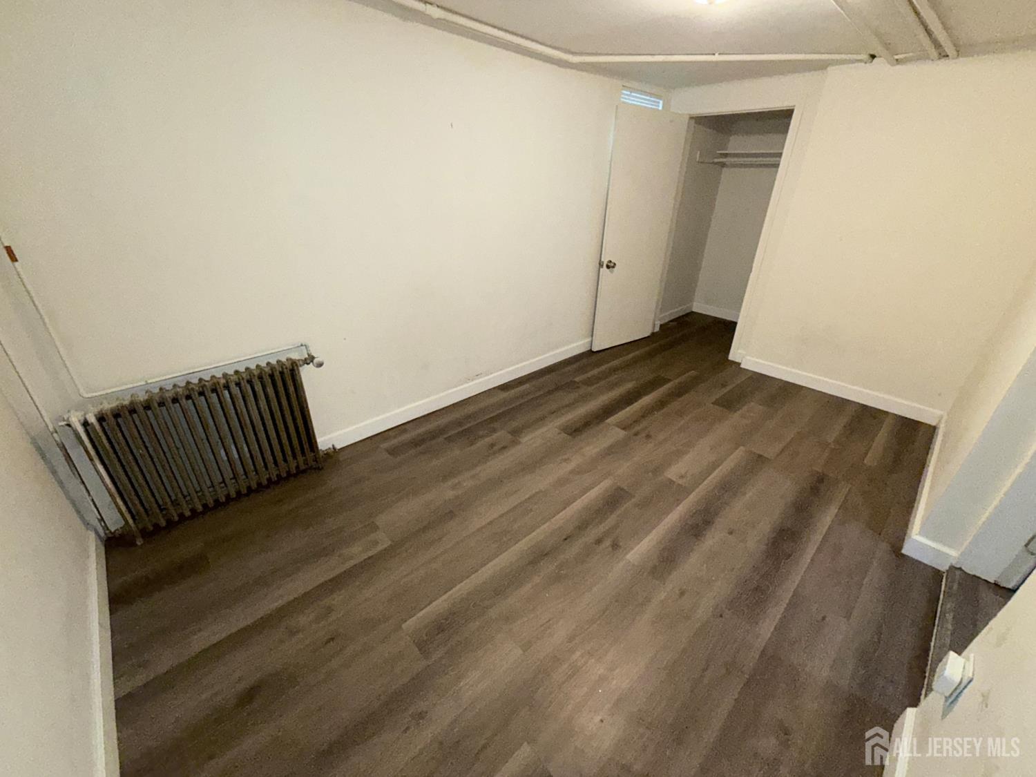 41 Atlantic Street Keyport, NJ 07735 - Photo 33 of 48 a view of a room with wooden floor and white walls