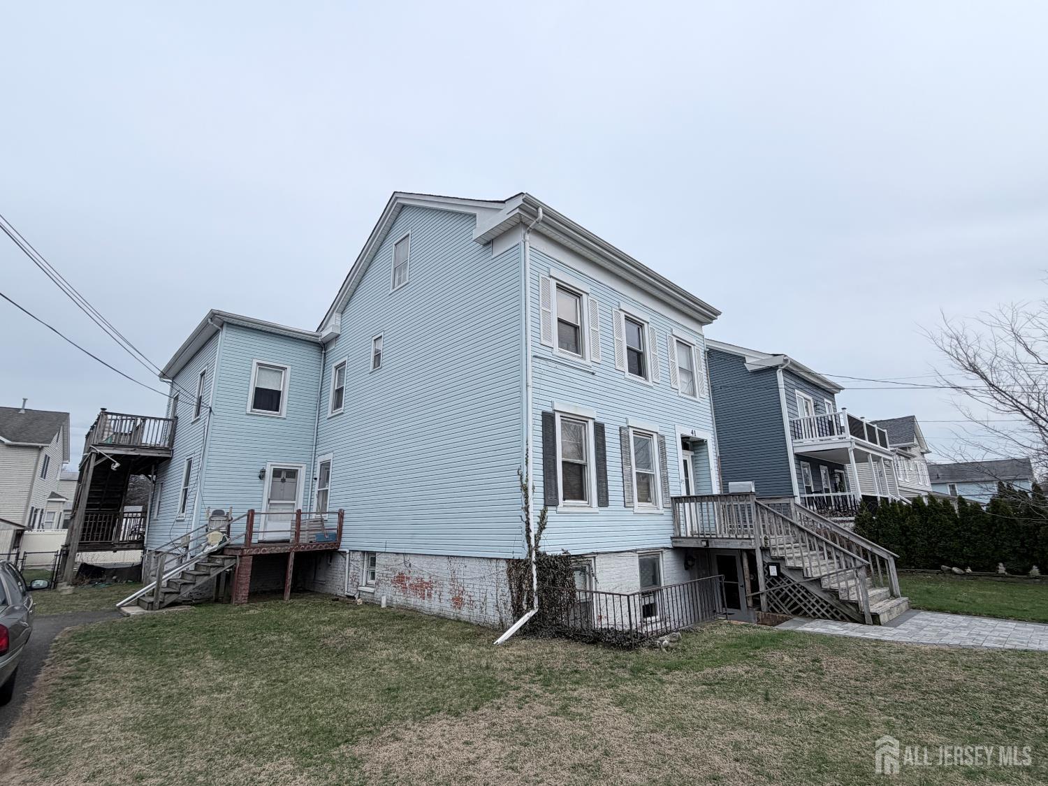 41 Atlantic Street Keyport, NJ 07735 - Photo 35 of 48 a view of a big house with many windows and a yard