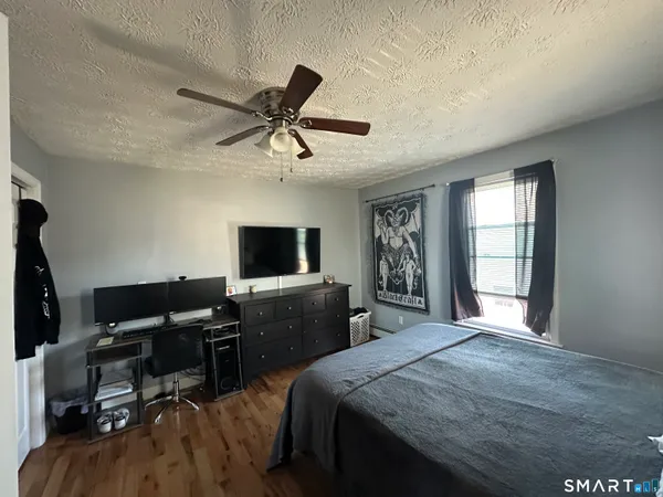 a bedroom with a bed and a flat screen tv