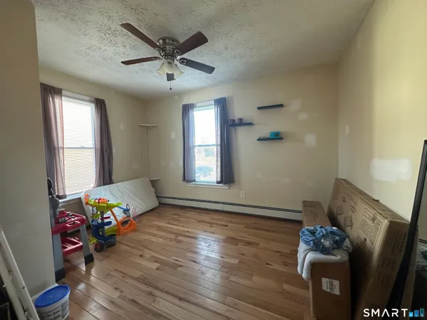 a bedroom with furniture and wooden floor