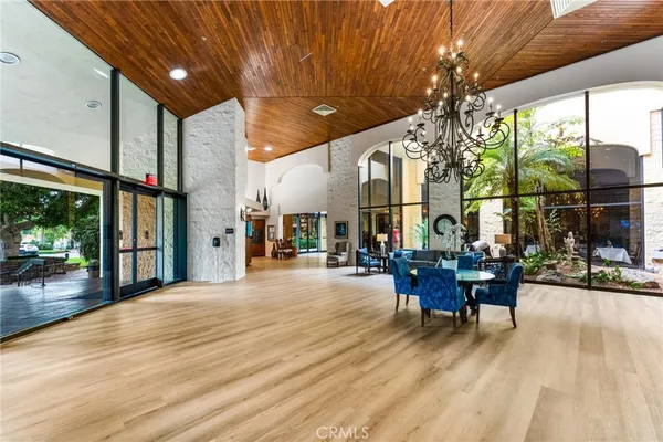a view of a patio with table and chairs and floor to ceiling window