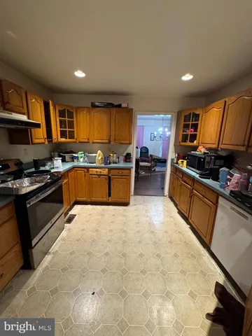 a kitchen with stainless steel appliances granite countertop a stove sink and cabinets