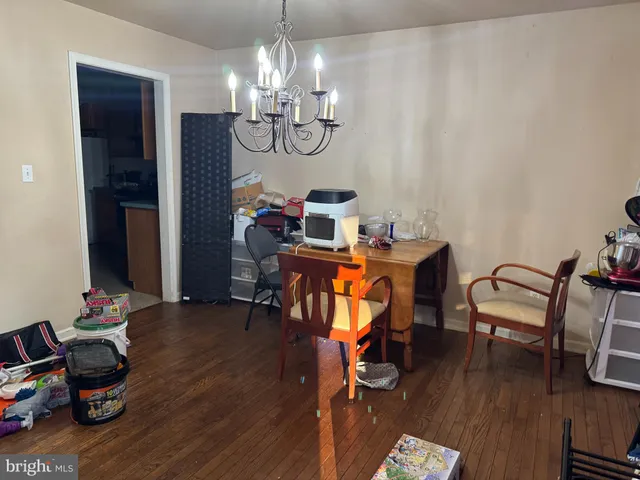 a balcony with wooden floor table and chairs