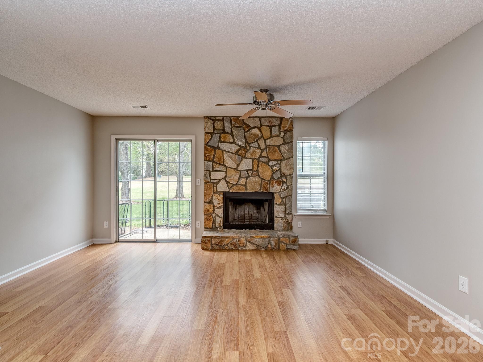 8211 Golf Ridge Drive Charlotte, NC 28277 - Photo 11 of 40 wooden floor fireplace and windows in an empty room