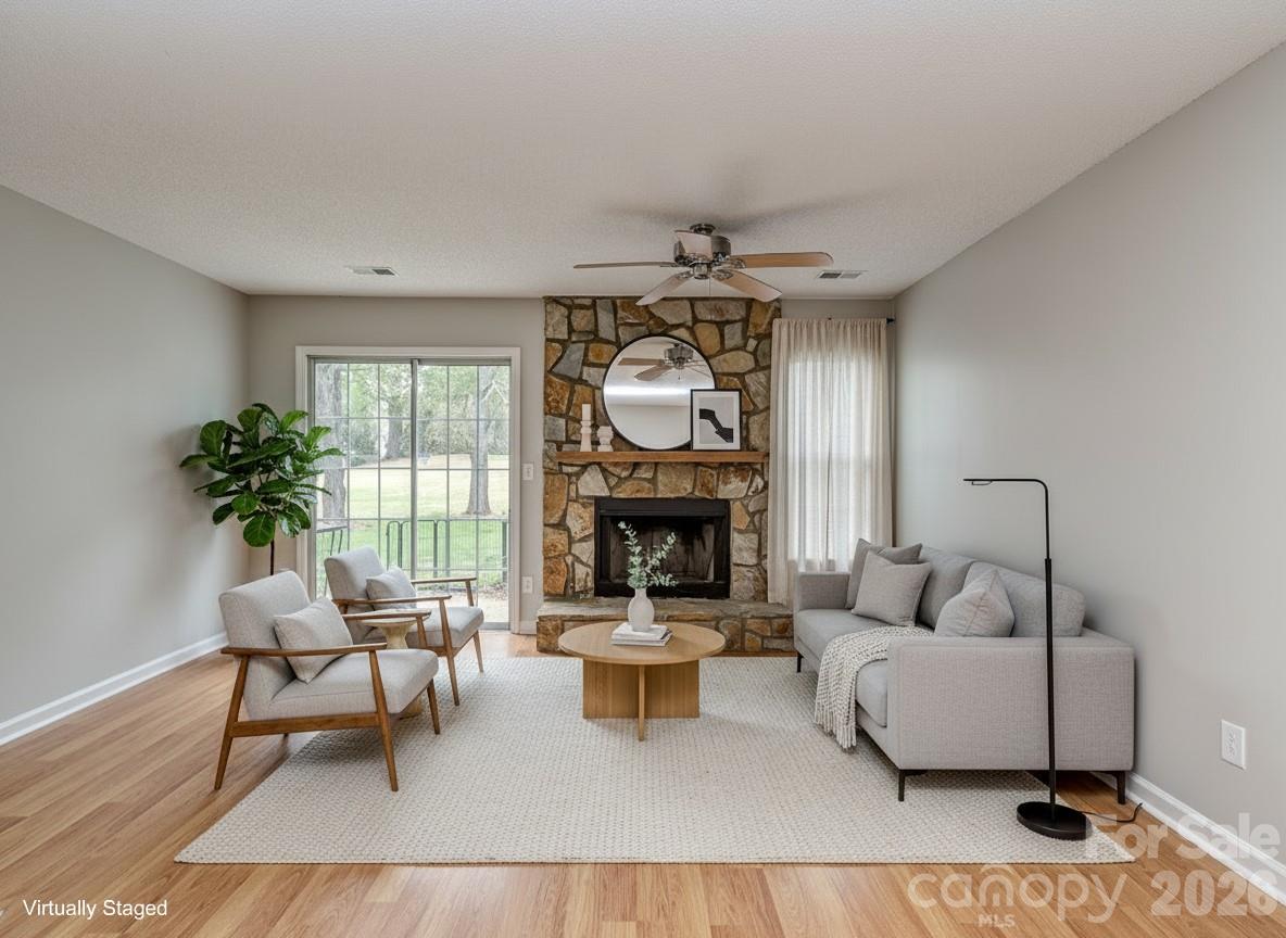 8211 Golf Ridge Drive Charlotte, NC 28277 - Photo 12 of 40 a living room with furniture a fireplace and a potted plant