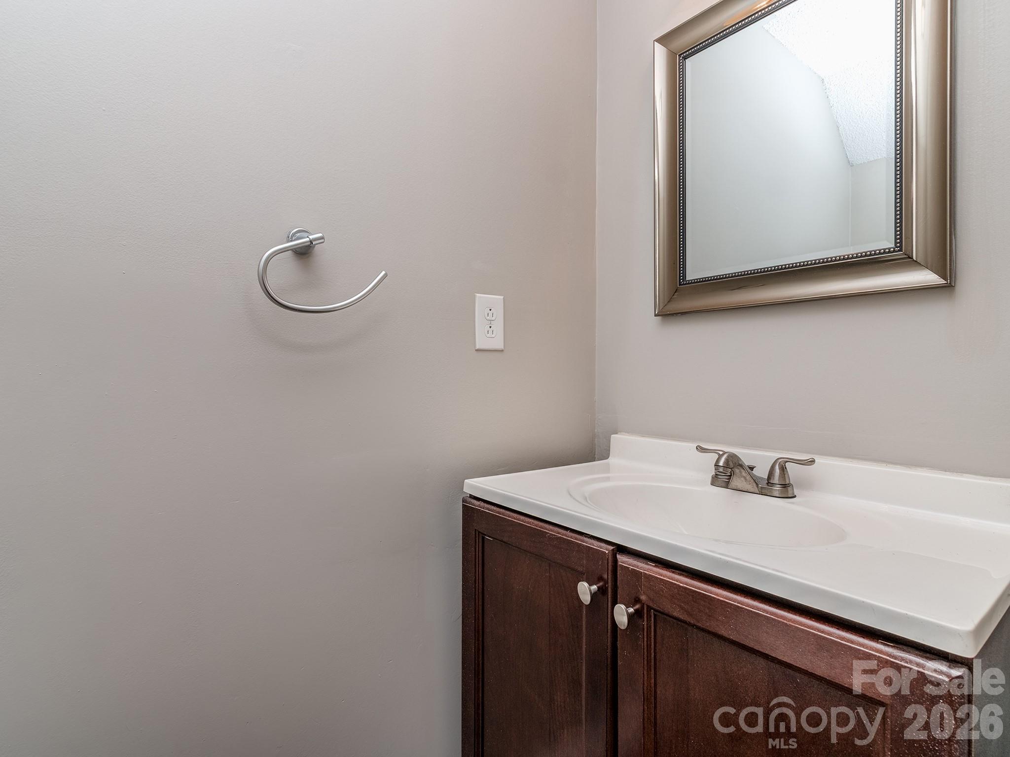 8211 Golf Ridge Drive Charlotte, NC 28277 - Photo 16 of 40 a bathroom with a sink and a mirror
