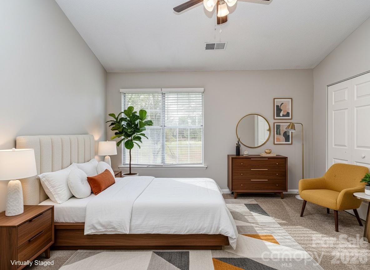 8211 Golf Ridge Drive Charlotte, NC 28277 - Photo 18 of 40 a bedroom with bed and a chandelier