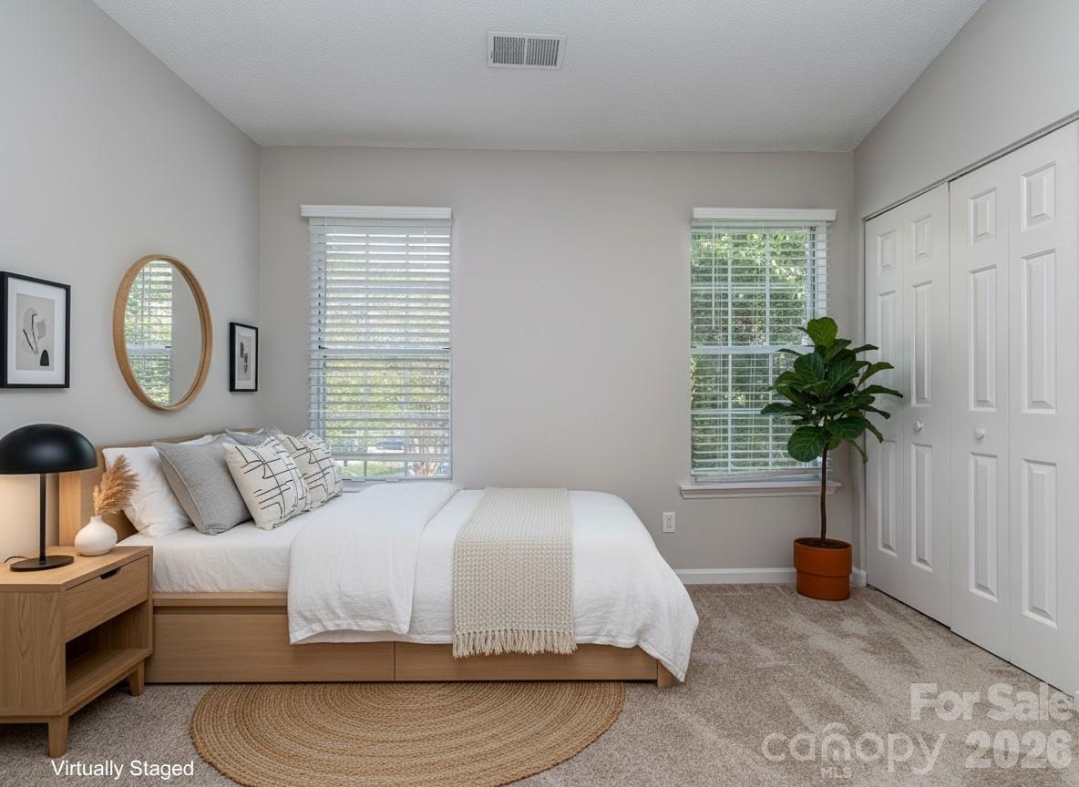 8211 Golf Ridge Drive Charlotte, NC 28277 - Photo 24 of 40 a bedroom with a bed a chandelier and a window