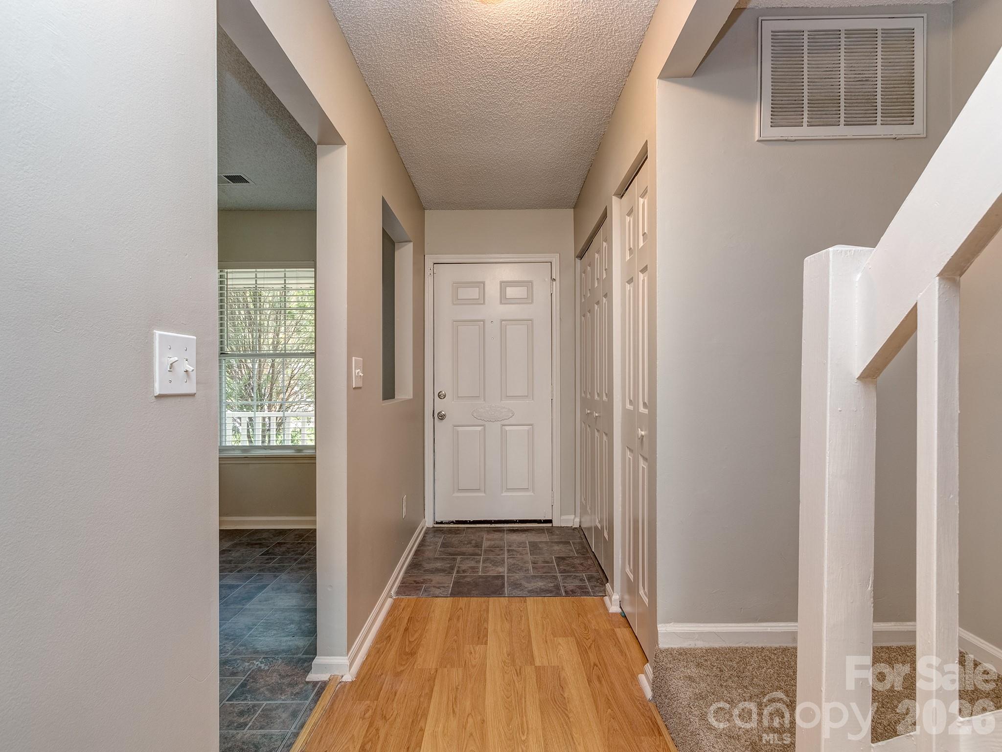 8211 Golf Ridge Drive Charlotte, NC 28277 - Photo 3 of 40 a view of a hallway with wooden floor and staircase