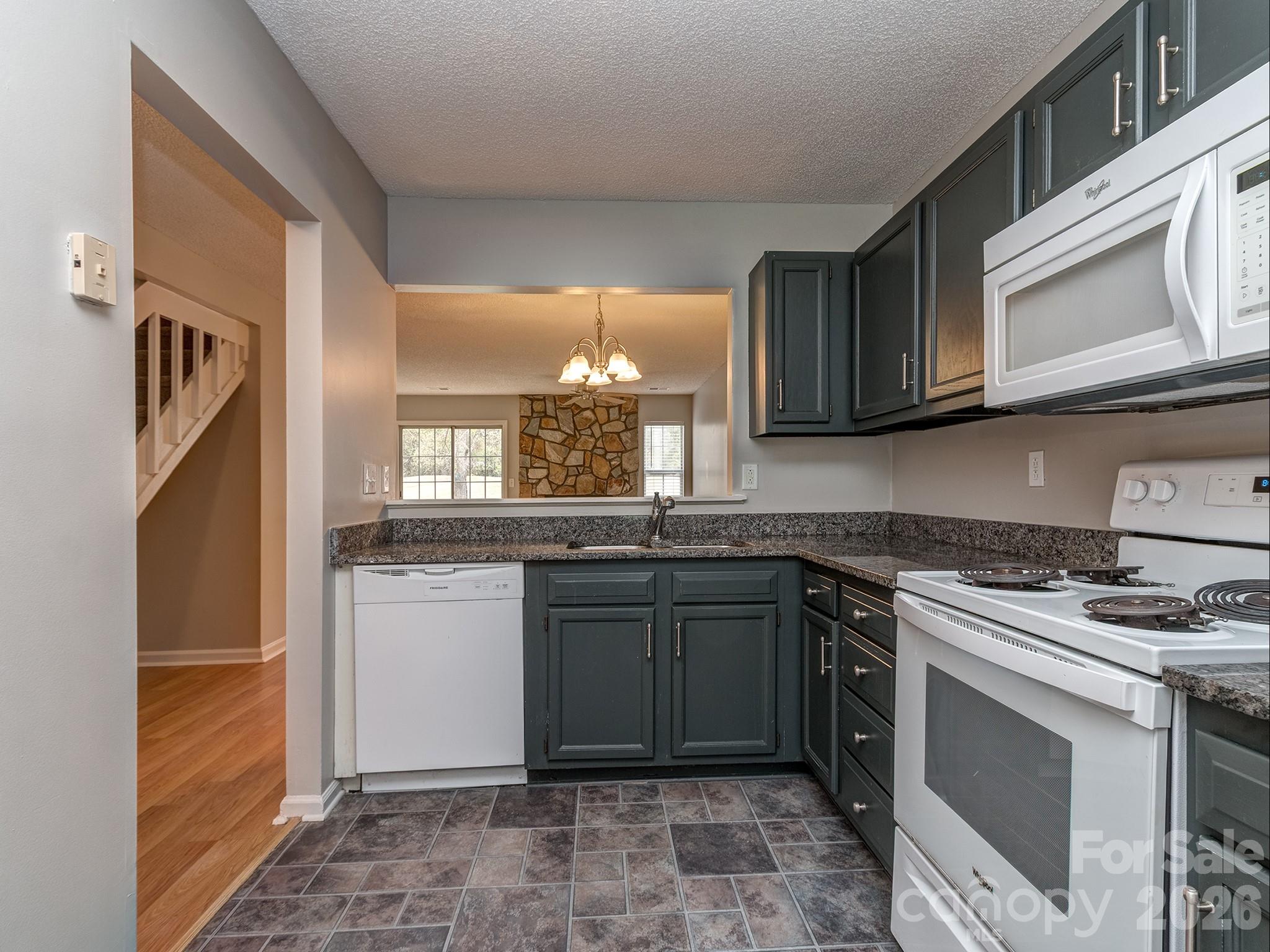 8211 Golf Ridge Drive Charlotte, NC 28277 - Photo 4 of 40 a kitchen with stainless steel appliances granite countertop a stove a sink and a refrigerator