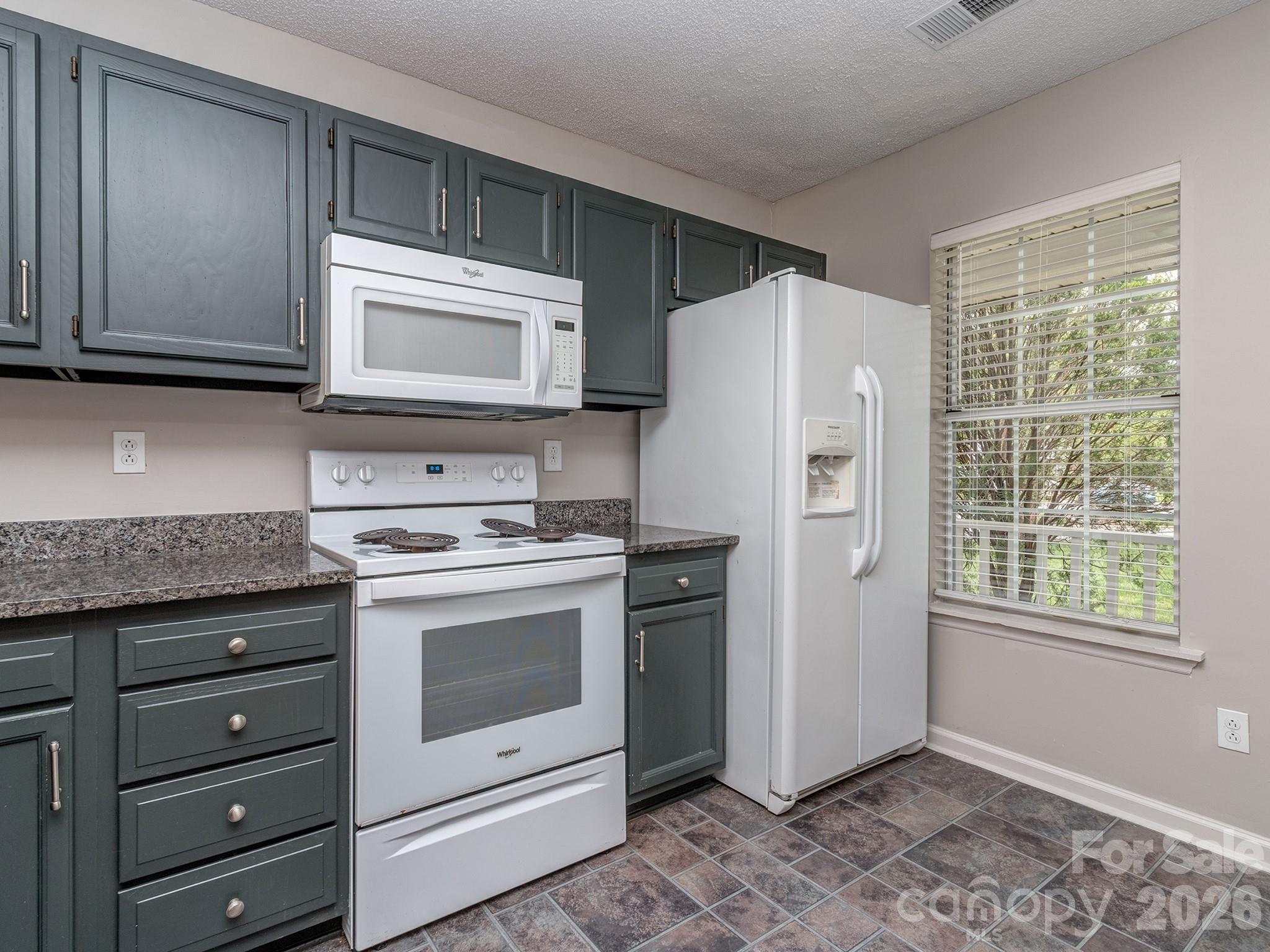8211 Golf Ridge Drive Charlotte, NC 28277 - Photo 5 of 40 a kitchen with granite countertop cabinets stainless steel appliances and a window