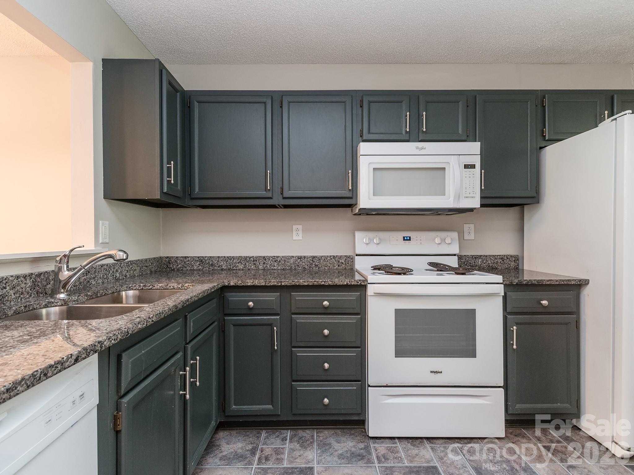 8211 Golf Ridge Drive Charlotte, NC 28277 - Photo 6 of 40 a kitchen with a stove and a microwave