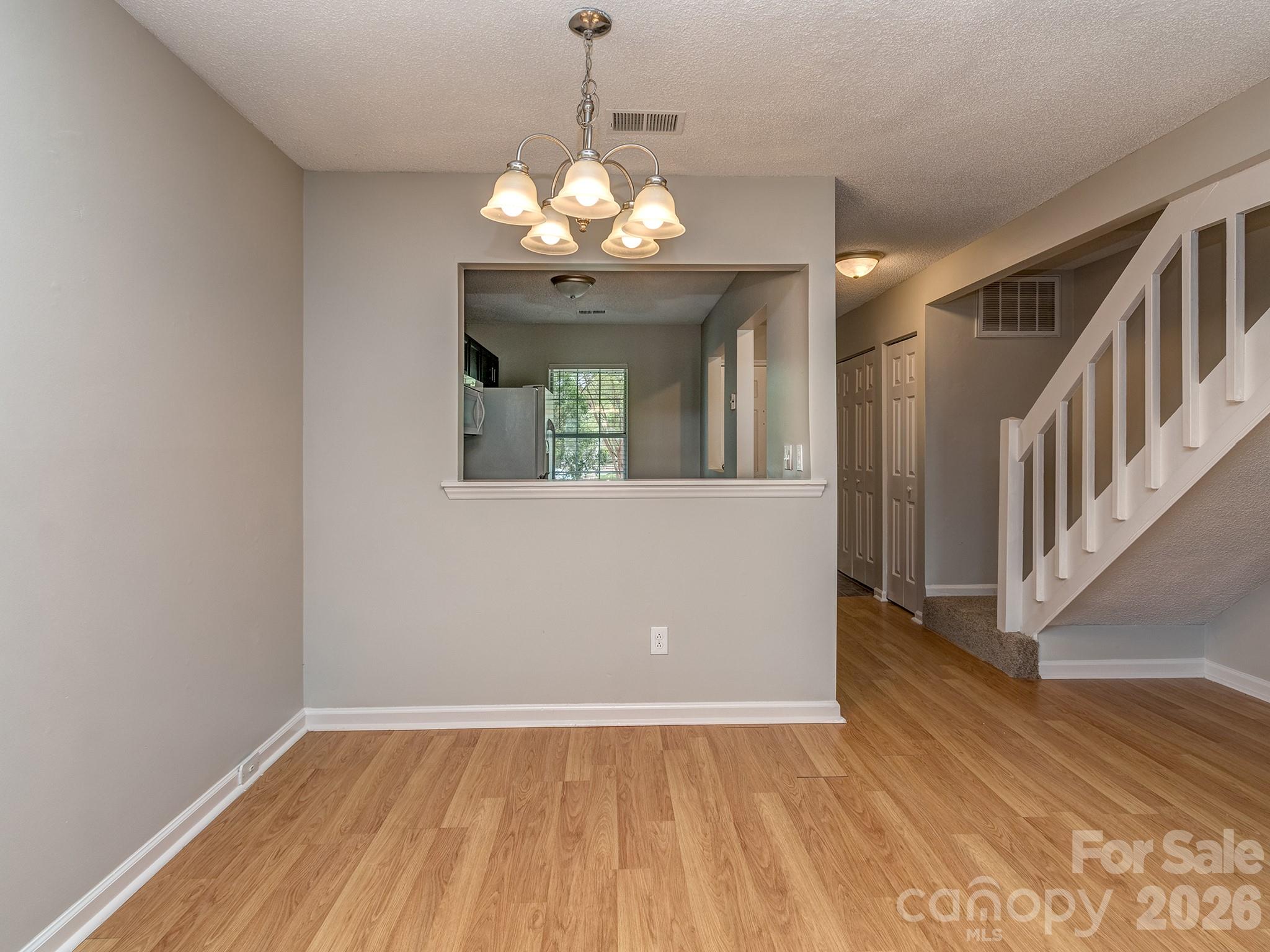 8211 Golf Ridge Drive Charlotte, NC 28277 - Photo 8 of 40 a view of an room with wooden floor and chandelier