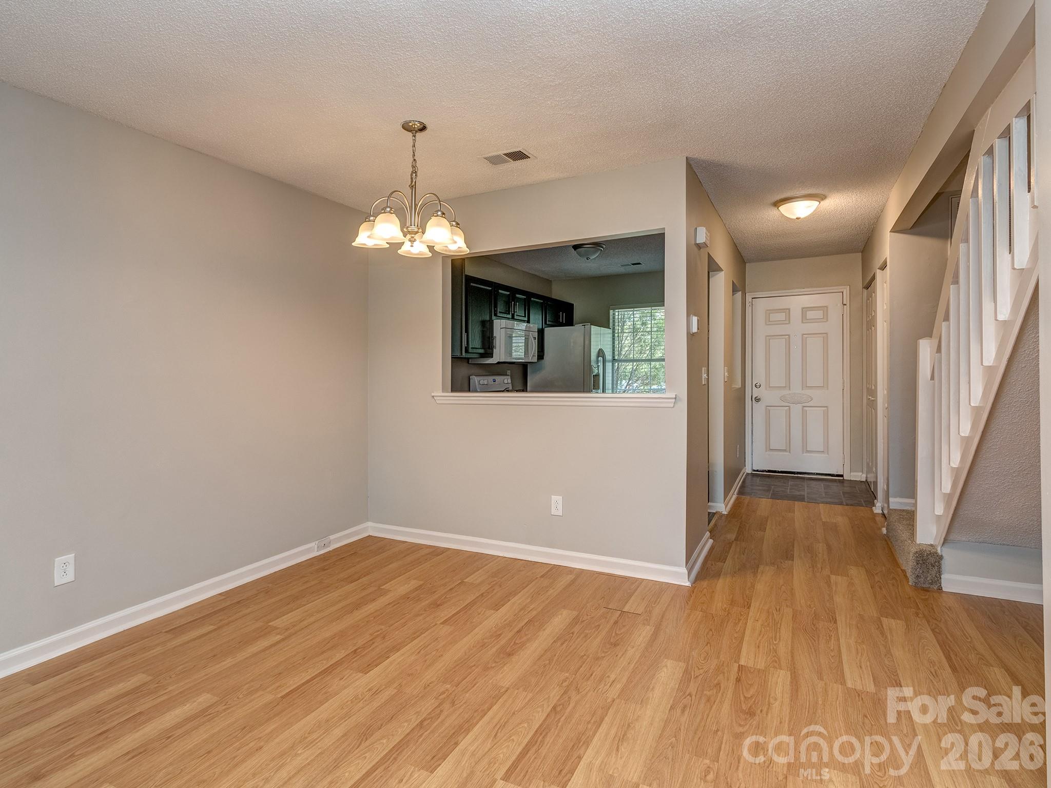 8211 Golf Ridge Drive Charlotte, NC 28277 - Photo 10 of 40 a view of a room with wooden floor and chandelier