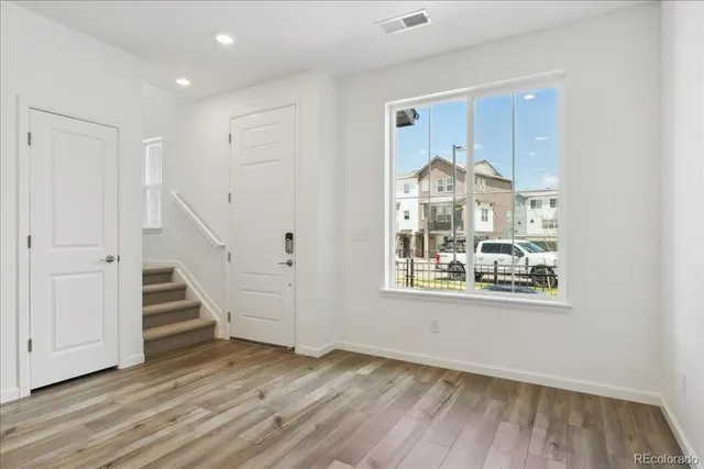 a view of a room with wooden floor staircase and windows