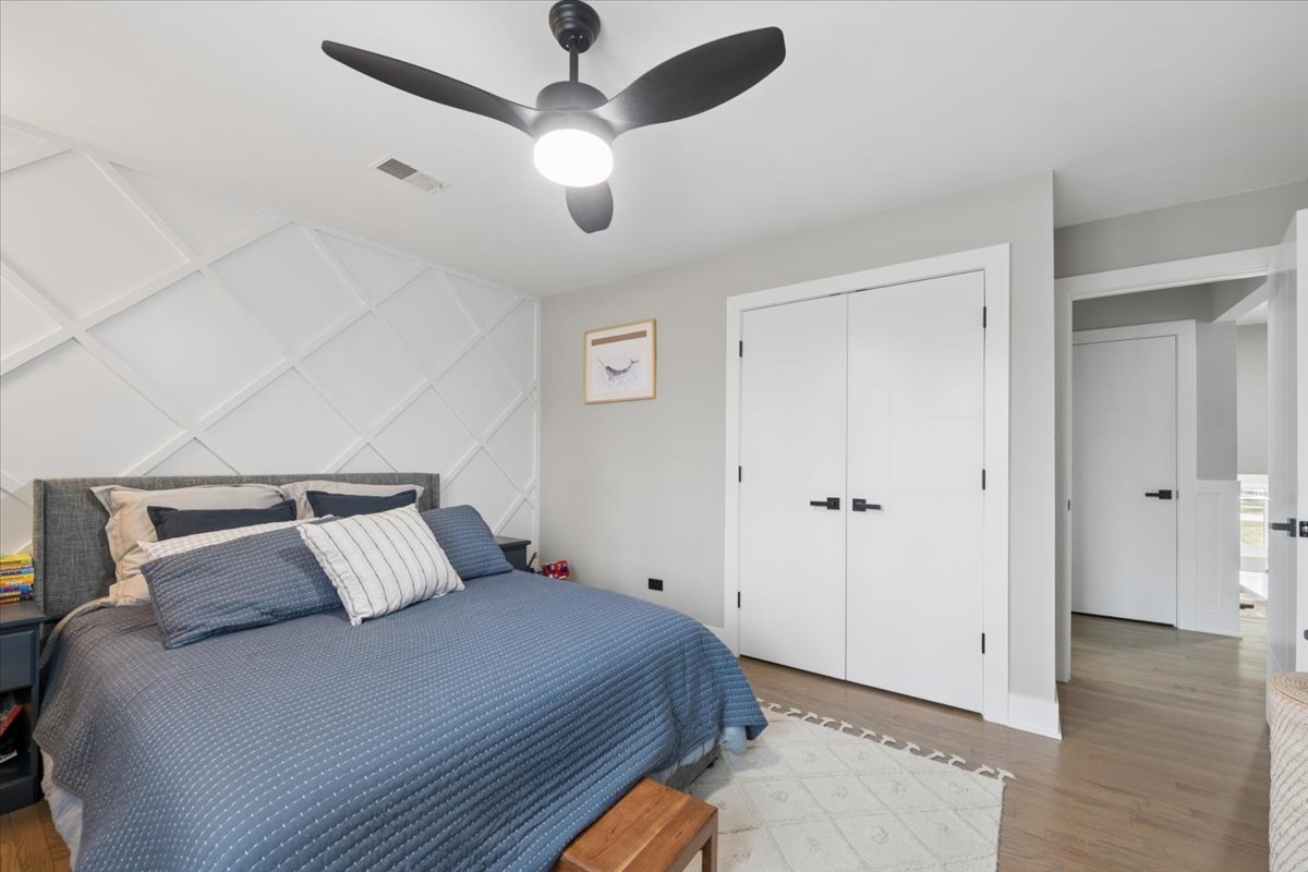 571 Byrd Road Riverside, IL 60546 - Photo 14 of 31 a bedroom with a large bed and a chandelier