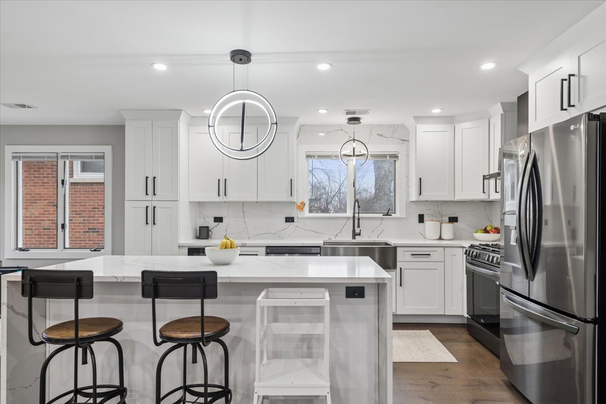 571 Byrd Road Riverside, IL 60546 - Photo 5 of 31 a kitchen with a sink a refrigerator and cabinets