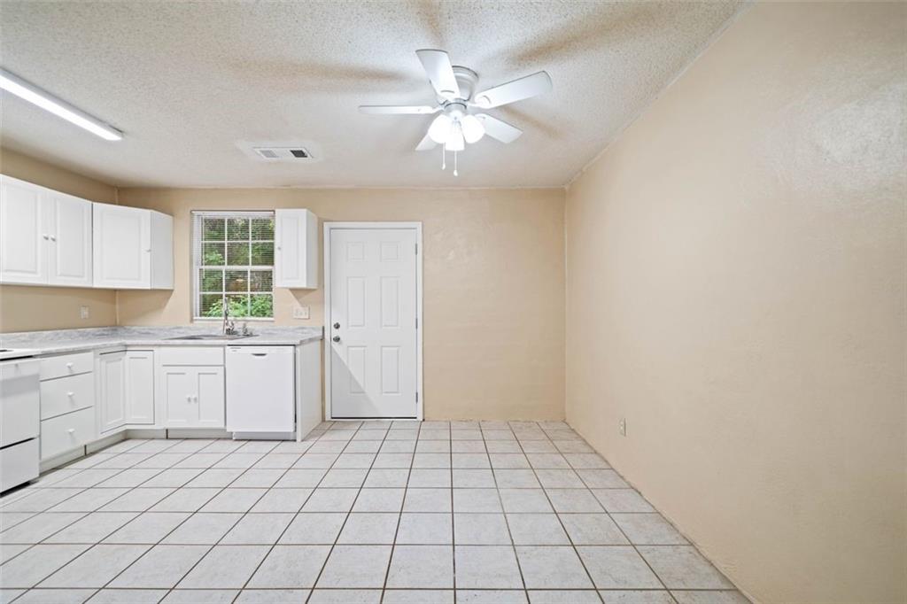 1628 Rockmart Road Villa Rica, GA 30180 - Photo 13 of 40 a kitchen with a sink cabinets and window