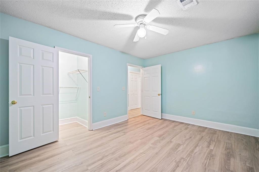 1628 Rockmart Road Villa Rica, GA 30180 - Photo 22 of 40 an empty room with wooden floor and ceiling fan