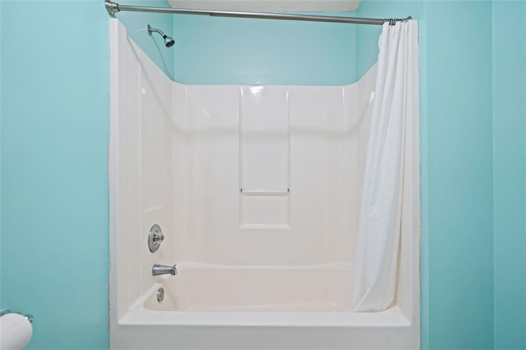 1628 Rockmart Road Villa Rica, GA 30180 - Photo 29 of 40 a bathroom with a bathtub and a shower