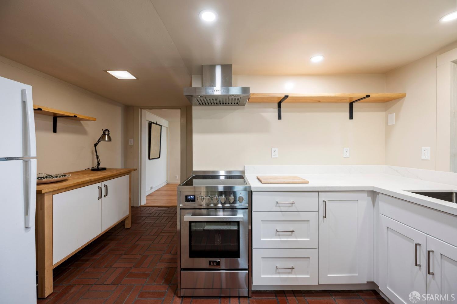 1659 Jackson Street San Francisco, CA 94109 - Photo 11 of 27 a kitchen with stainless steel appliances granite countertop a stove and a refrigerator