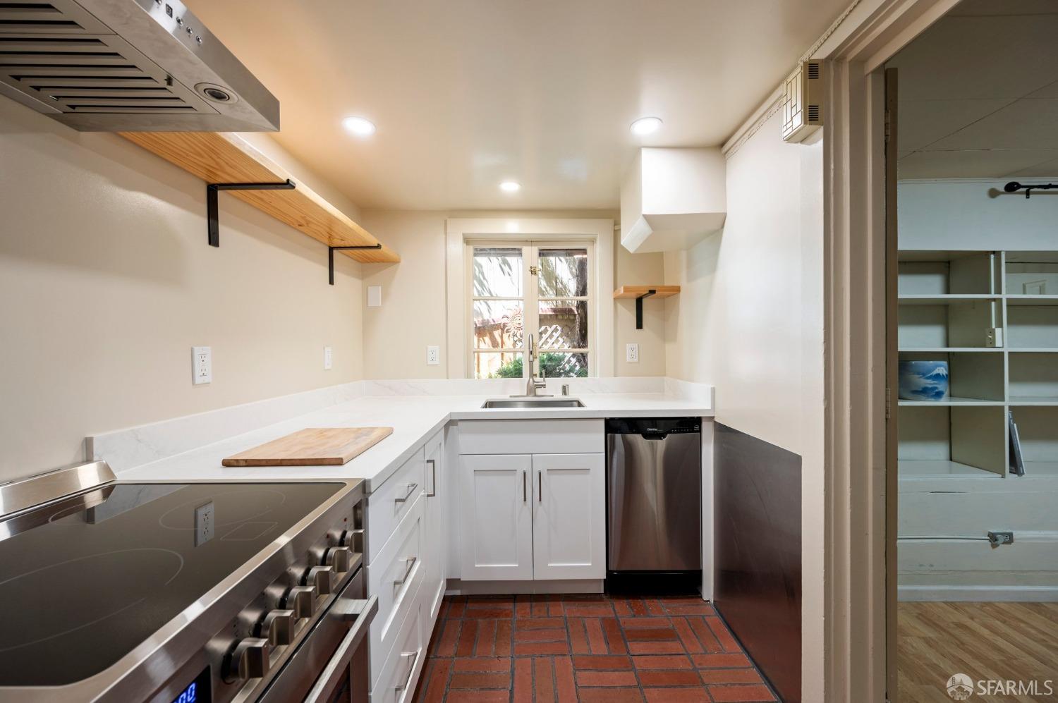 1659 Jackson Street San Francisco, CA 94109 - Photo 12 of 27 a kitchen with a sink appliances and cabinets