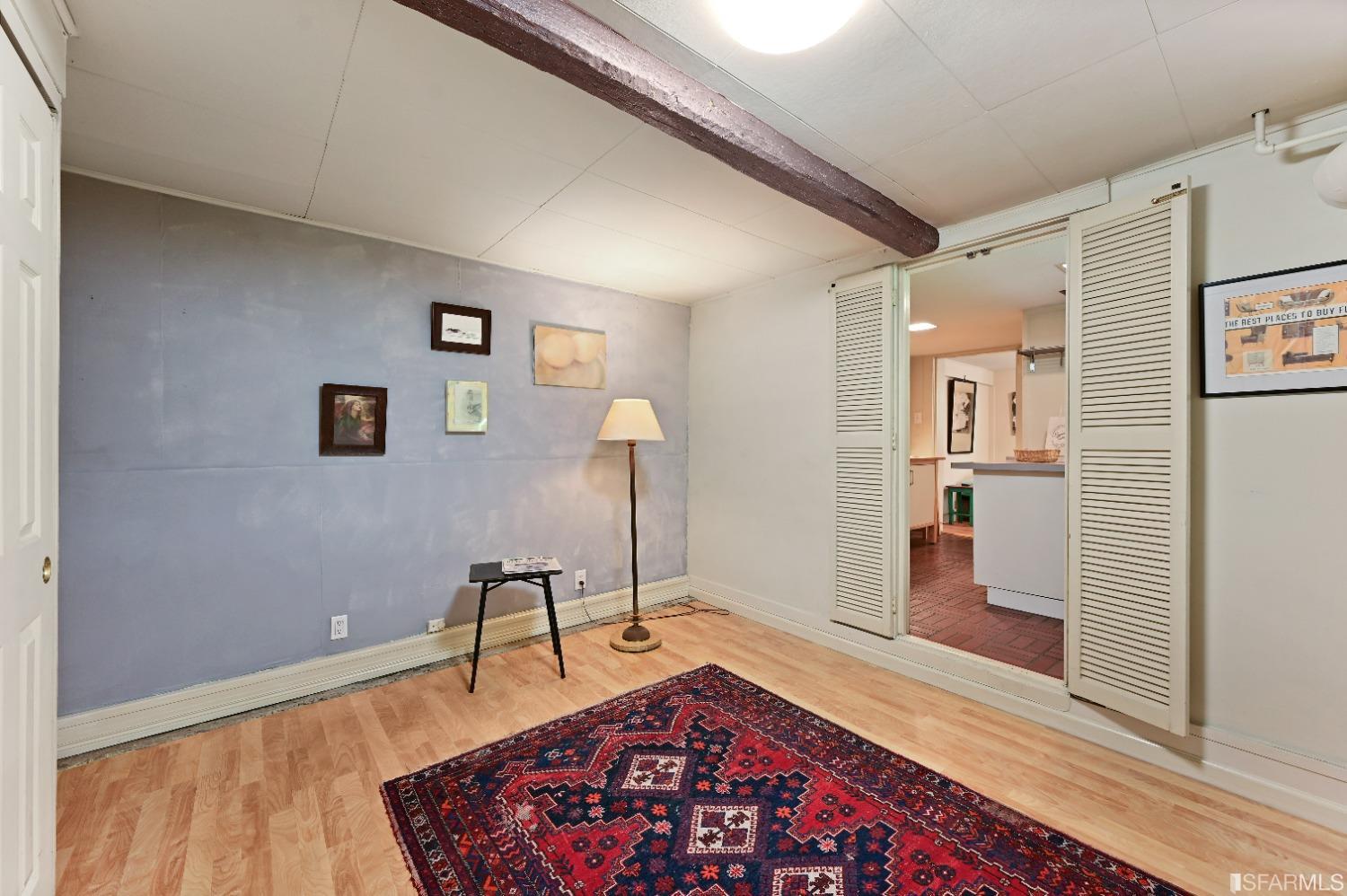 1659 Jackson Street San Francisco, CA 94109 - Photo 15 of 27 a living room with couch and wooden floor