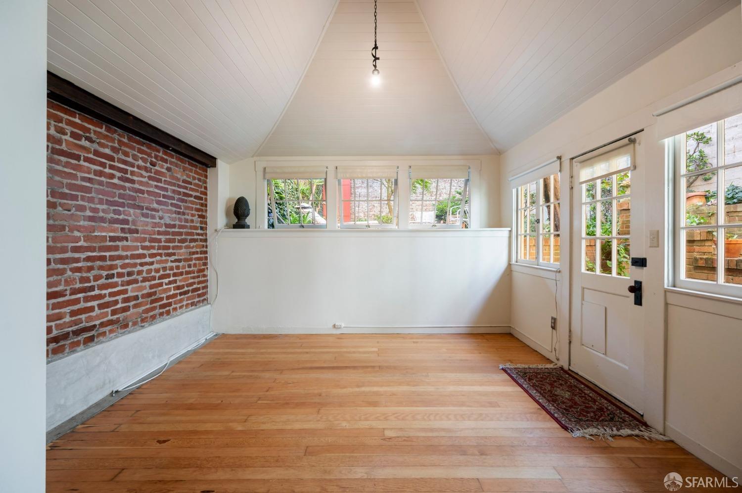 1659 Jackson Street San Francisco, CA 94109 - Photo 2 of 27 a view of an empty room with a window and wooden floor