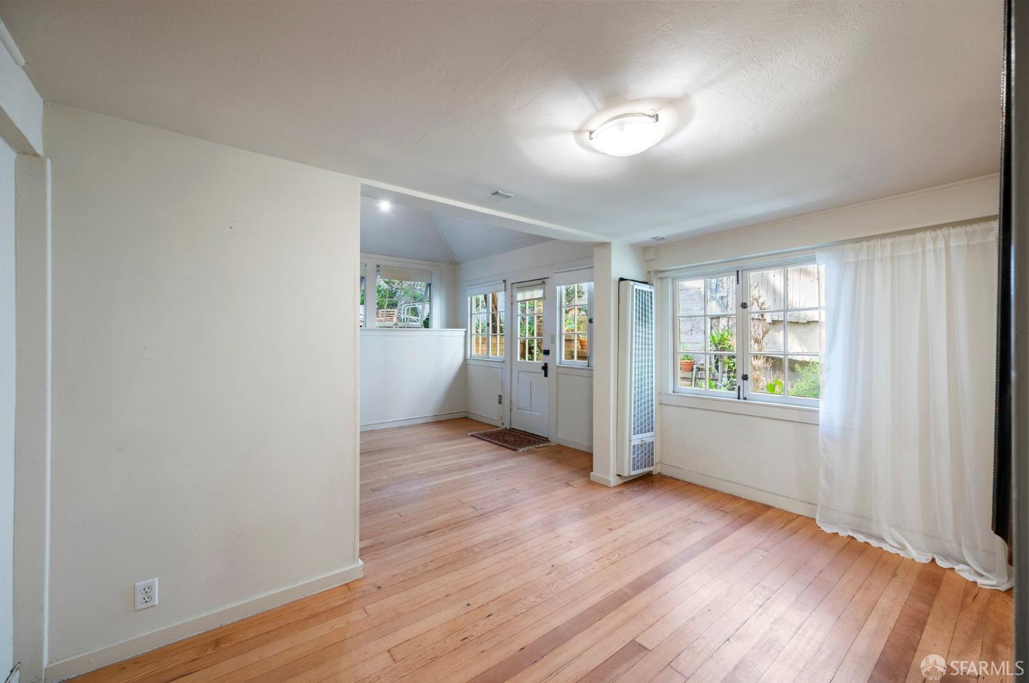 1659 Jackson Street San Francisco, CA 94109 - Photo 26 of 27 an empty room with wooden floor and windows