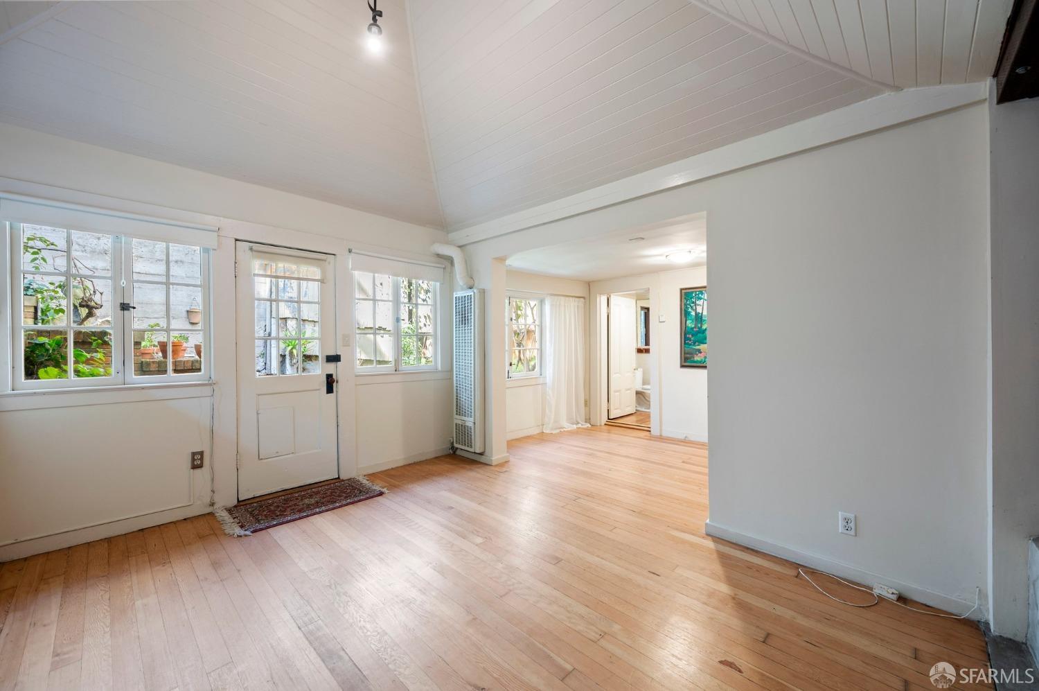 1659 Jackson Street San Francisco, CA 94109 - Photo 27 of 27 a view of an empty room with wooden floor and a window