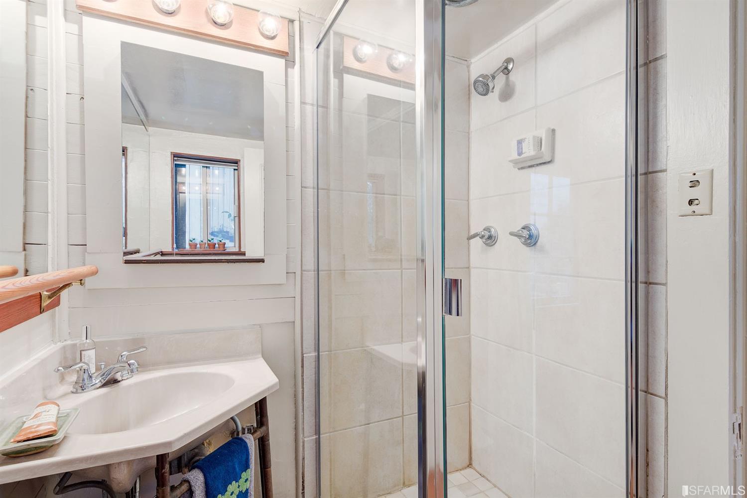 1659 Jackson Street San Francisco, CA 94109 - Photo 6 of 27 a bathroom with a sink and a mirror