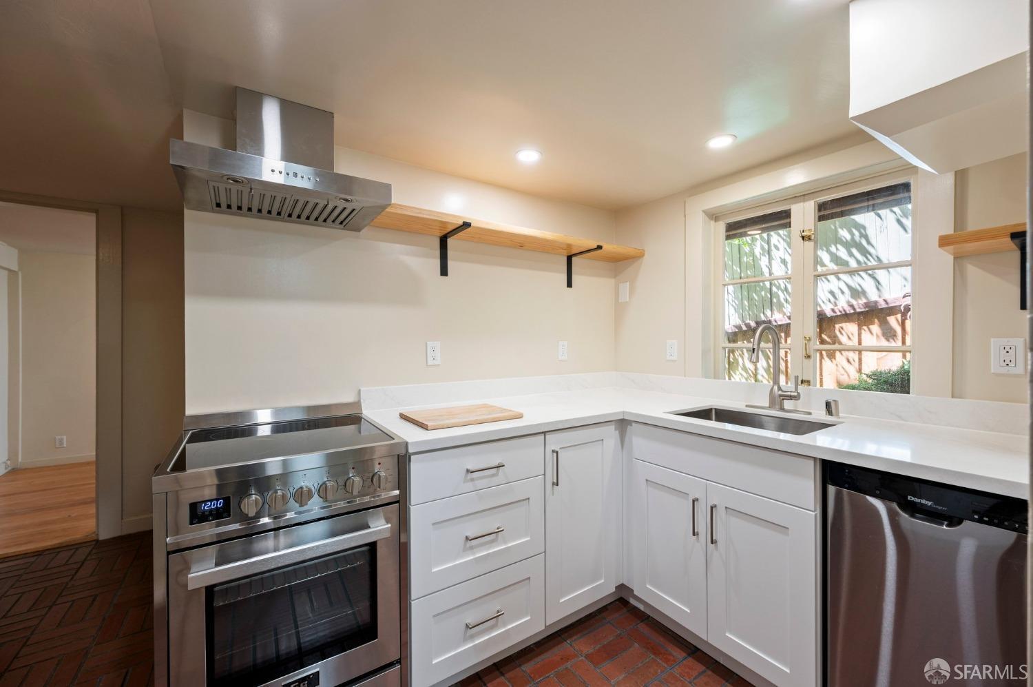 1659 Jackson Street San Francisco, CA 94109 - Photo 10 of 27 a kitchen with a sink stove and microwave