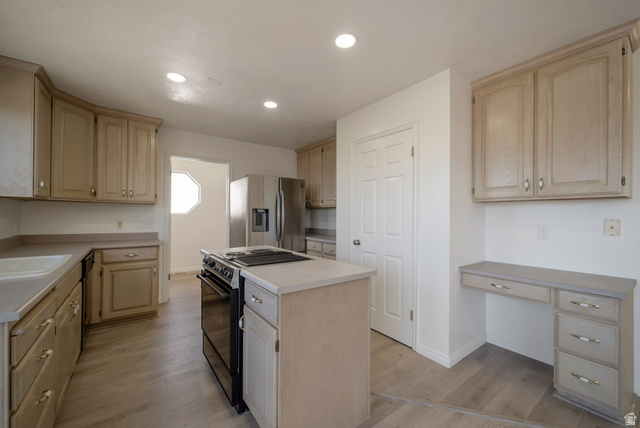 11922 Bluff View Drive Sandy, UT 84092 - Photo 9 of 30 Kitchen with light wood finish cabinetry, stainless steel appliances, light countertops, light wood-style floors, and recessed lighting