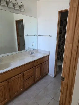 a spacious bathroom with a sink and mirror