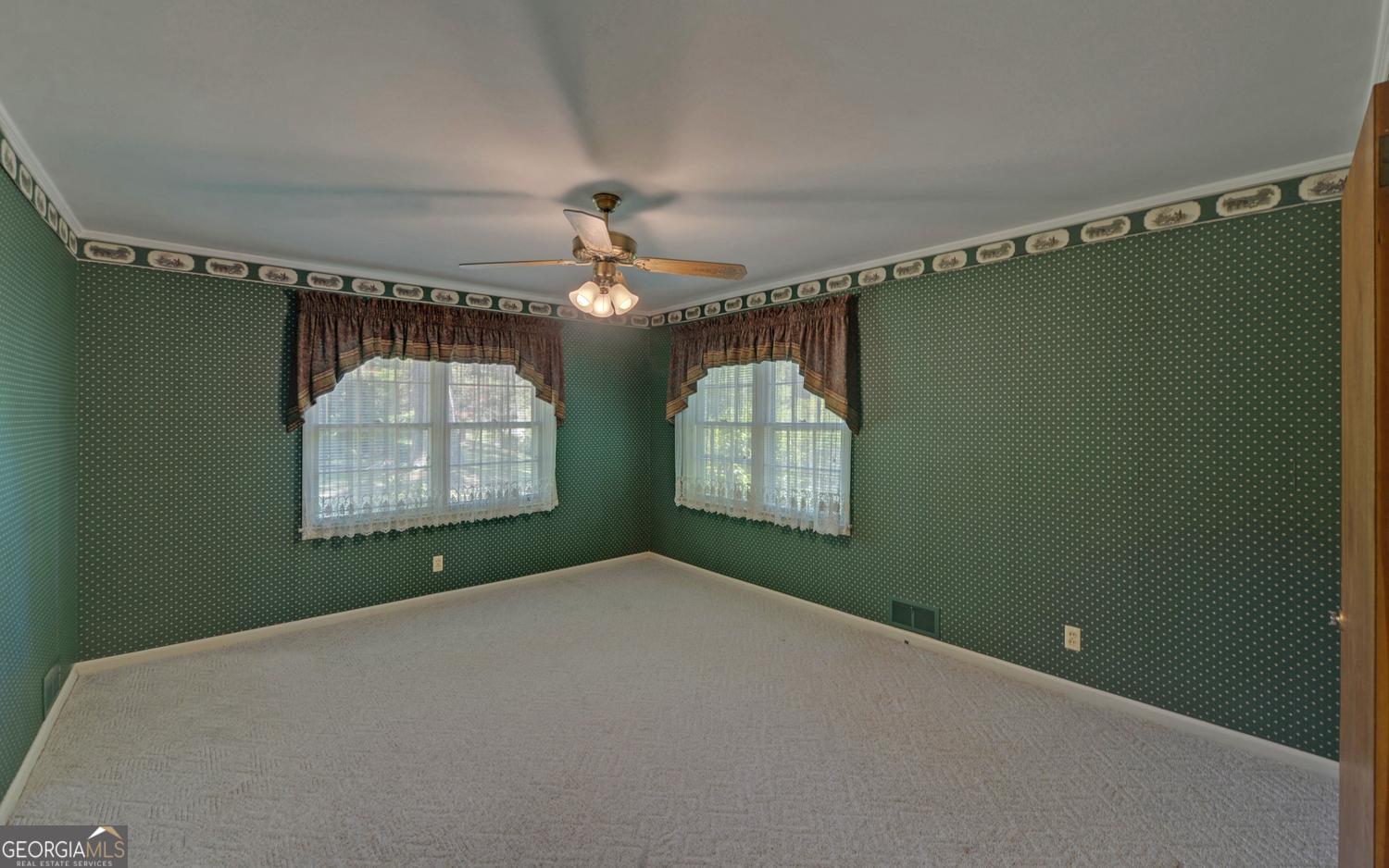 400 Harris Street Toccoa, GA 30577 - Photo 20 of 49 en empty room with windows and fan