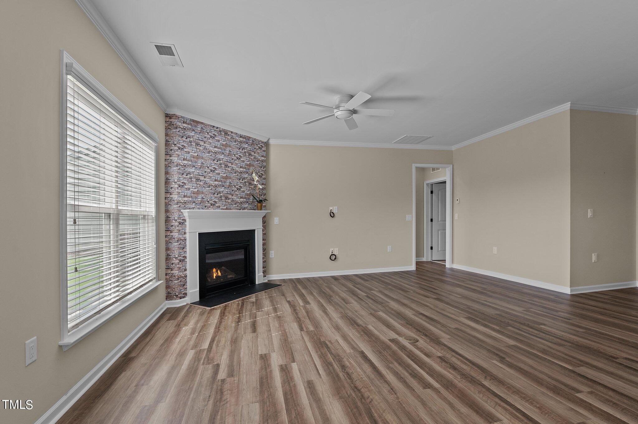 1013 Calista Drive Wake Forest, NC 27587 - Photo 12 of 40 a view of empty room with wooden floor and fireplace