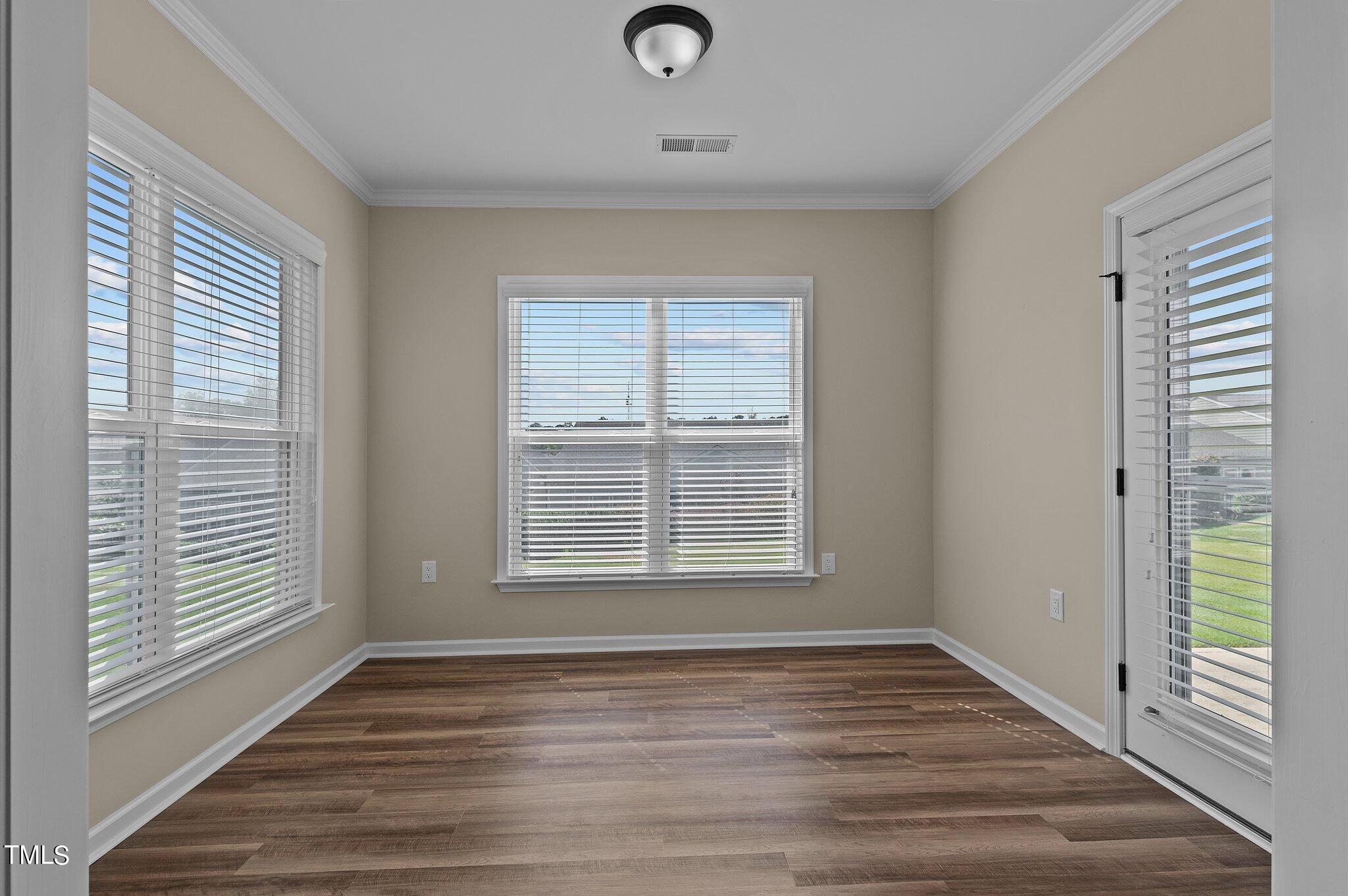 1013 Calista Drive Wake Forest, NC 27587 - Photo 20 of 40 a view of empty room with wooden floor and fan