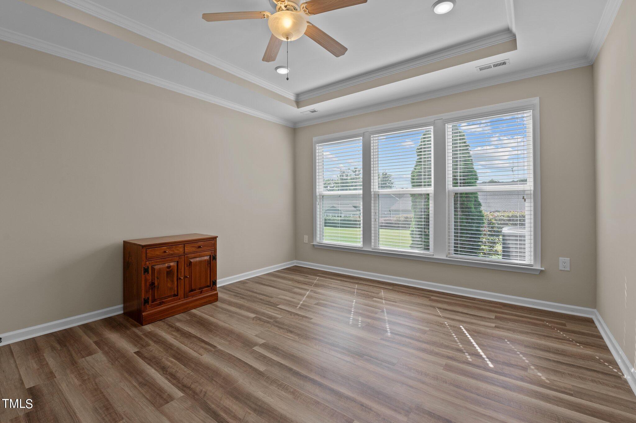 1013 Calista Drive Wake Forest, NC 27587 - Photo 23 of 40 a view of an empty room with a window and wooden floor