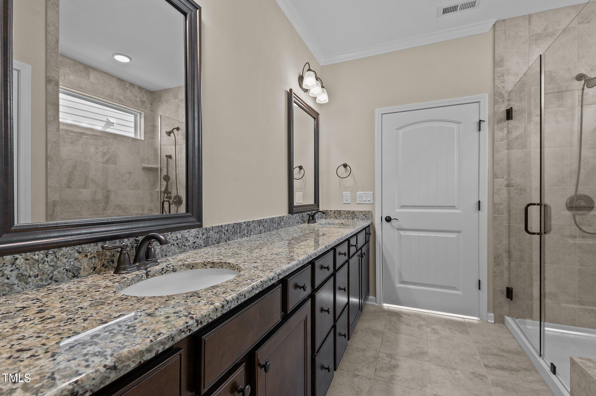1013 Calista Drive Wake Forest, NC 27587 - Photo 25 of 40 a bathroom with a granite countertop sink and a mirror