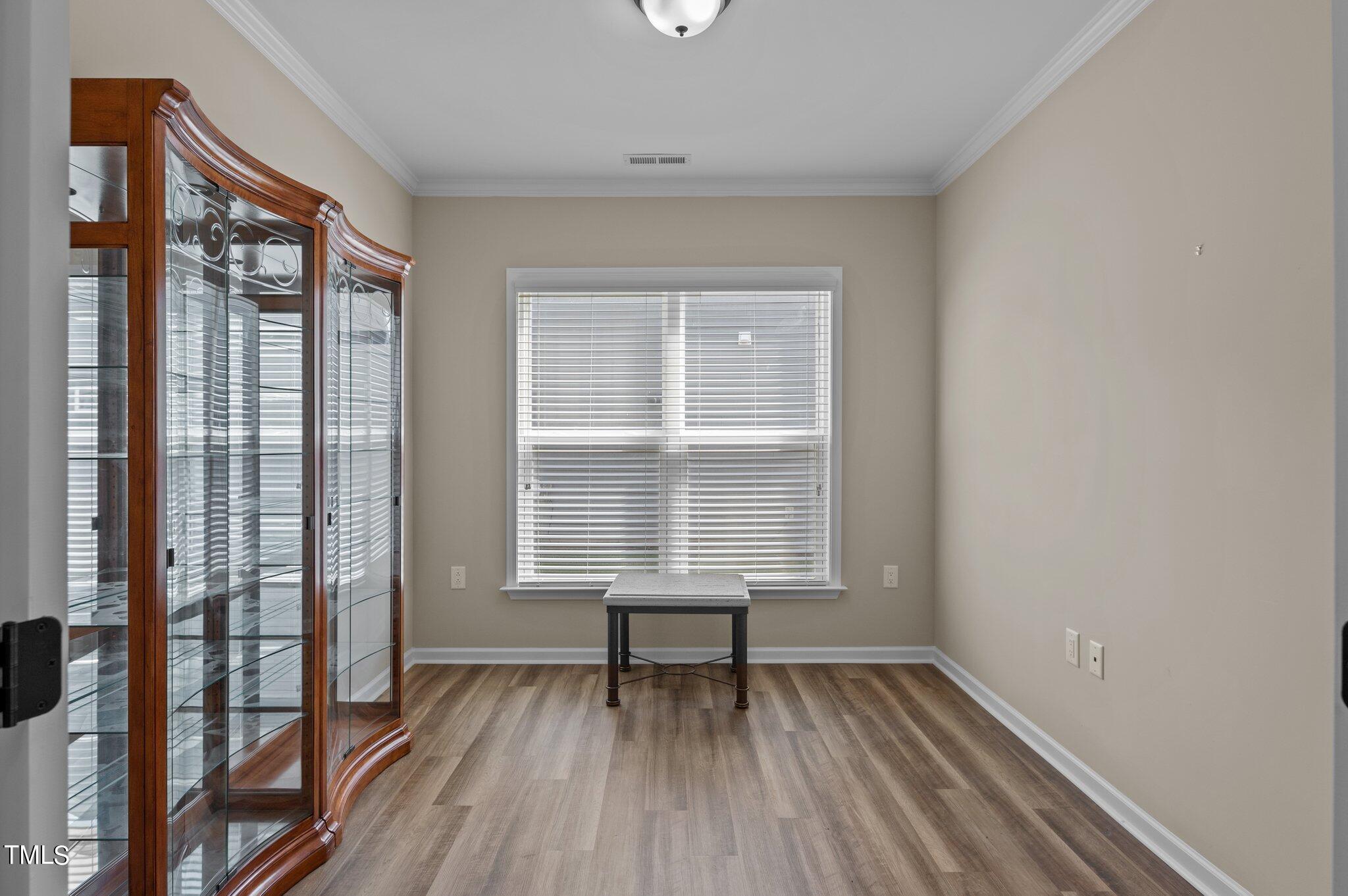 1013 Calista Drive Wake Forest, NC 27587 - Photo 7 of 40 a view of an empty room with wooden floor and a window