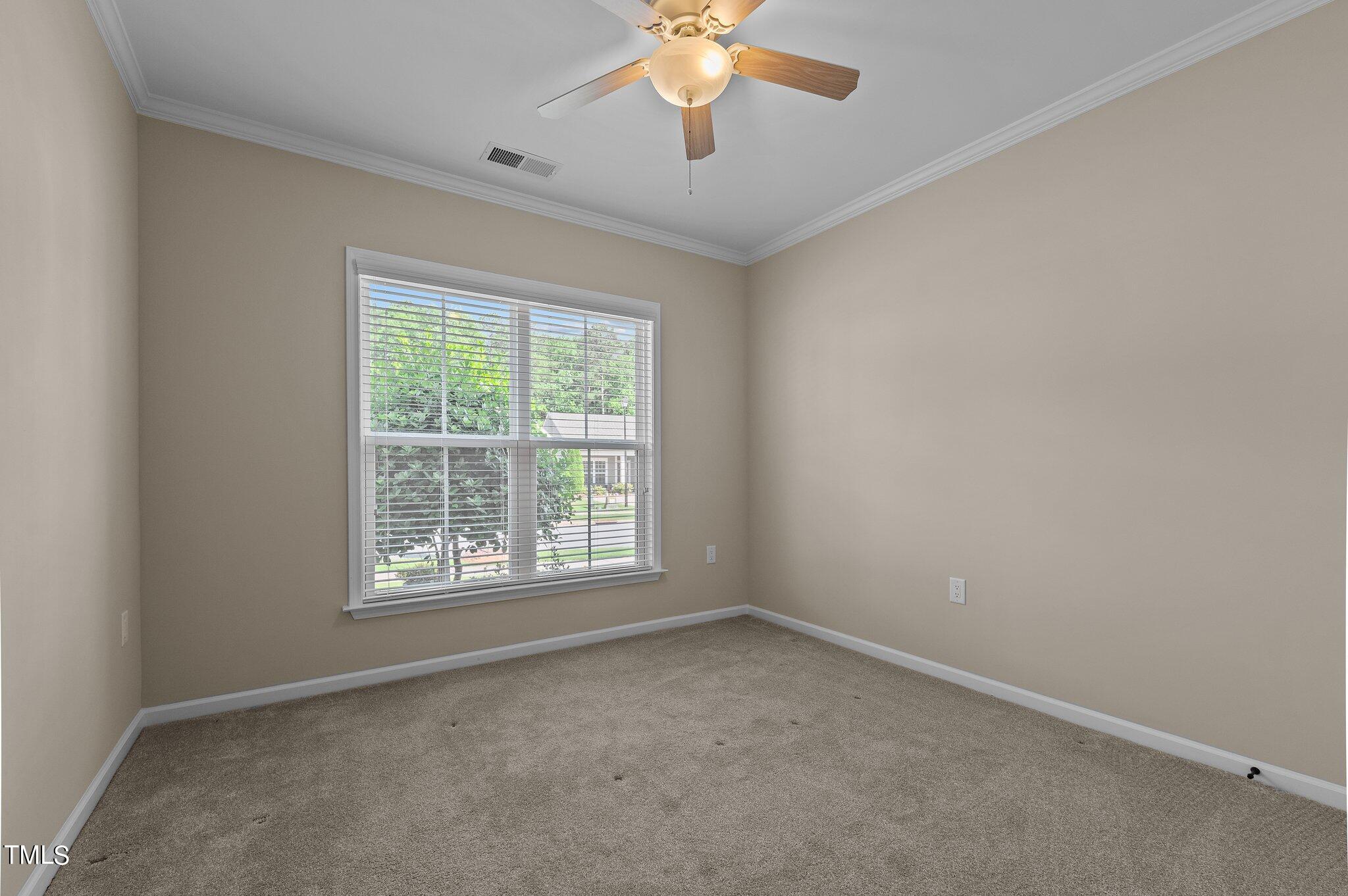 1013 Calista Drive Wake Forest, NC 27587 - Photo 10 of 40 an empty room with a window and a fan