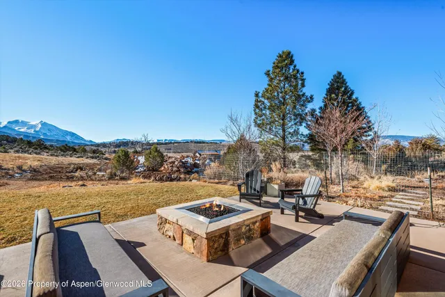 a view of a terrace with seating area and city view