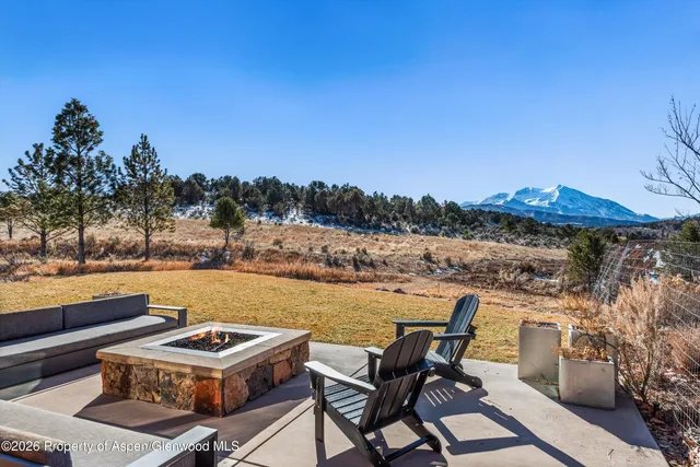 a view of a lake with couches chairs
