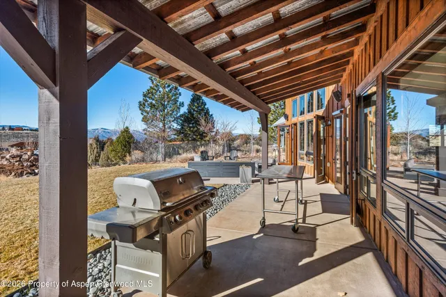 a view of a chairs and table in the balcony