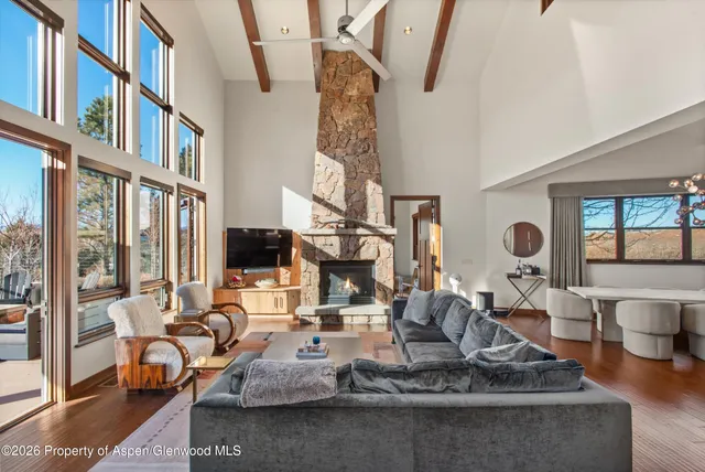 a living room with furniture and a floor to ceiling window