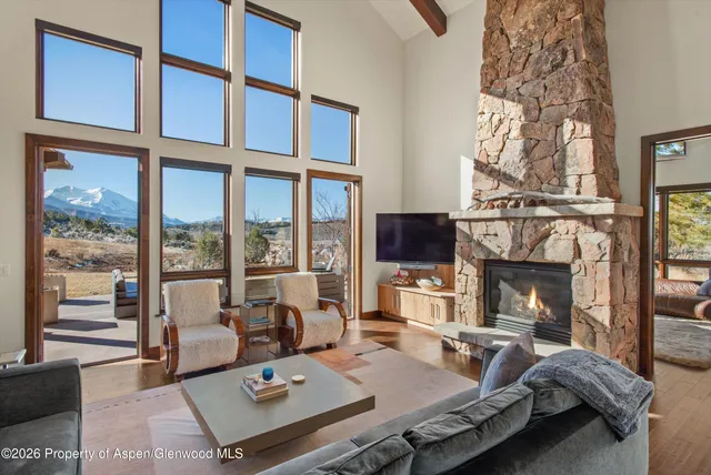 a living room with furniture fireplace and flat screen tv
