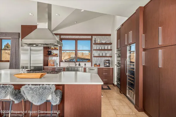 a large kitchen with a table and chairs