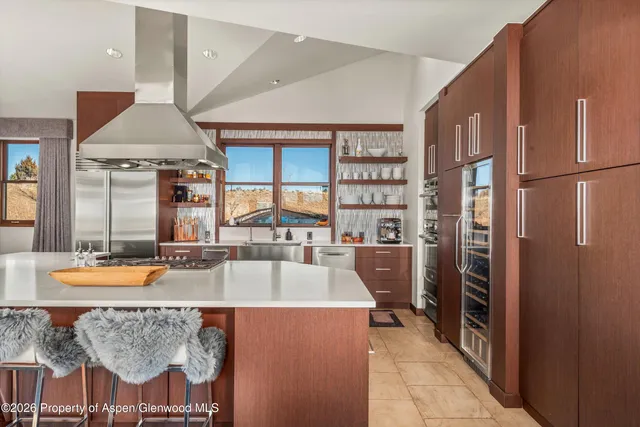 a large kitchen with a table and chairs